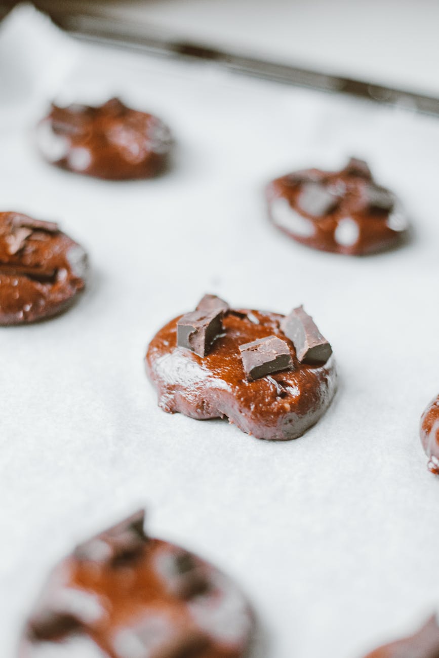 Close-up of chocolate chunk cookie dough on baking sheet ready to bake.