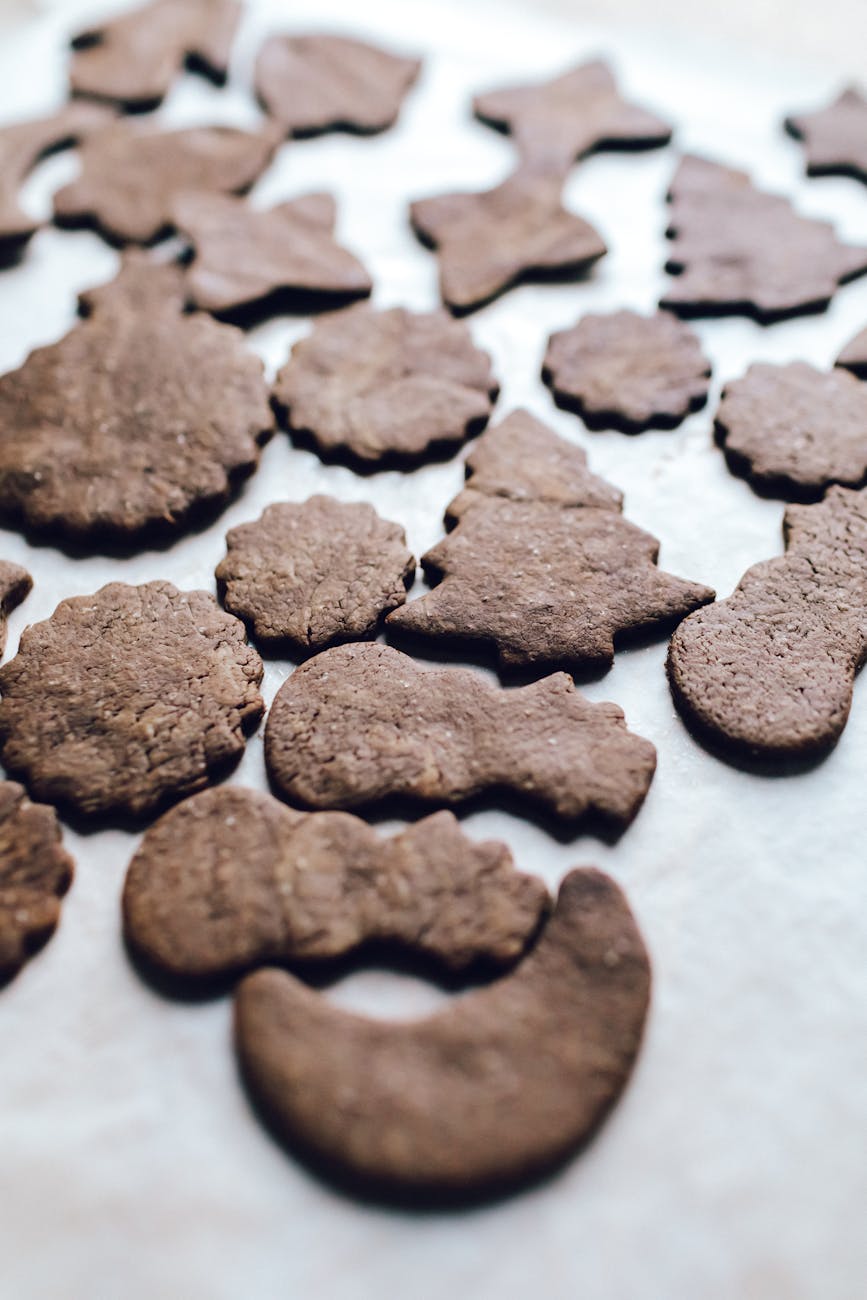 A delightful array of homemade chocolate cookies in festive shapes, perfect for holiday celebrations.